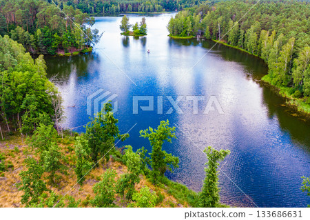 Aerial view yacht on lake in Tuchola Forests, Poland. Aerial view yacht on lake in Tuchola Forests, Poland. 133686631