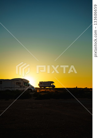Camper cars on beach at sunset Camper cars on beach at sunset 133686659