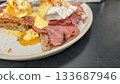A bee eating bacon on the Eggs Benedict on the toast plate 133687946