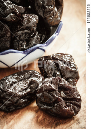 dried plums prunes on wooden table dried plums prunes on wooden table 133688226