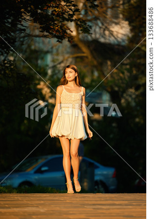 Slavic Woman Walking in Warm Golden Light Slavic Woman Walking in Warm Golden Light 133688486