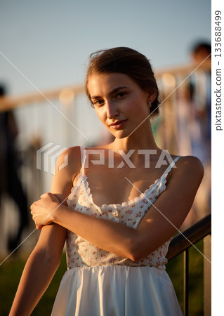Slavic Woman in White Lace Dress at Sunset 133688499