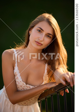 Slavic Woman in White Dress by Railing 133688500