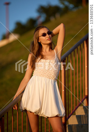 Slavic Woman in White Dress on Staircase 133688501