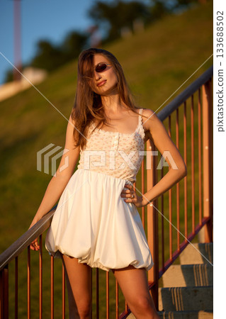 Slavic Woman in White Dress on Staircase Slavic Woman in White Dress on Staircase 133688502