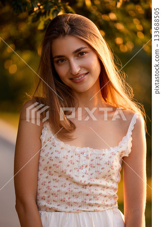 Slavic Woman in Sunlit Garden Wearing White Skirt Slavic Woman in Sunlit Garden Wearing White Skirt 133688505