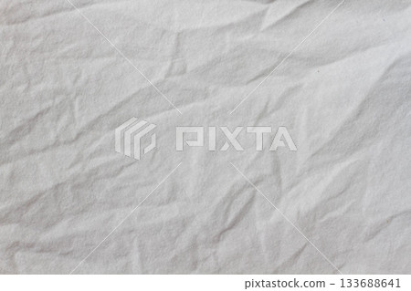Wrinkled sheet. White fabric close-up. Burlap texture. Sheet on the bed. Wrinkled sheet. White fabric close-up. Burlap texture. Sheet on the bed. 133688641