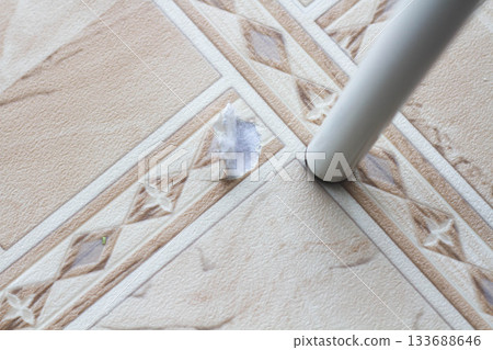 Ripped linoleum. Chair leg and torn linoleum. Hole in linoleum. 133688646