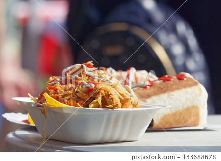 Street food meal with corn chips and pulled meat served at a food festival in Karlin, Prague 133688678