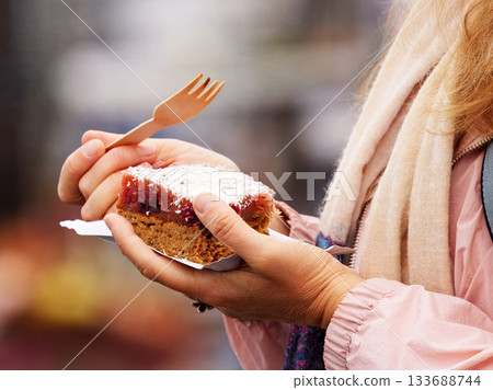 Woman enjoying fruit dessert at Prague farmers market 133688744