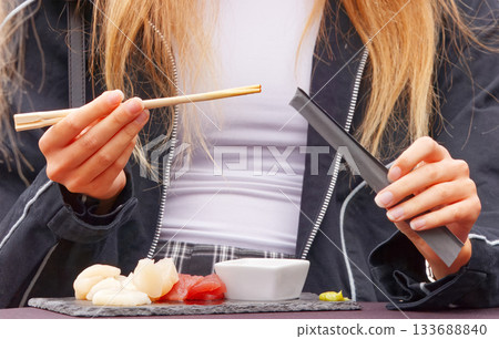 Young woman eating seafood at farmers market Young woman eating seafood at farmers market 133688840