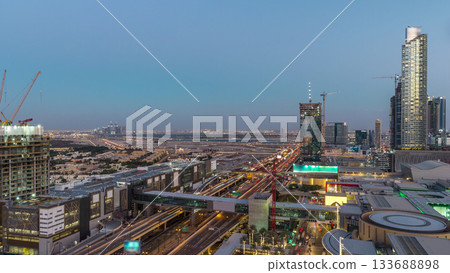 Aerial view of Financial center road day to night timelapse with under construction building Aerial view of Financial center road day to night timelapse with under construction building 133688898