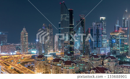 Aerial view of illuminated skyscrapers and road junction in Dubai timelapse Aerial view of illuminated skyscrapers and road junction in Dubai timelapse 133688901