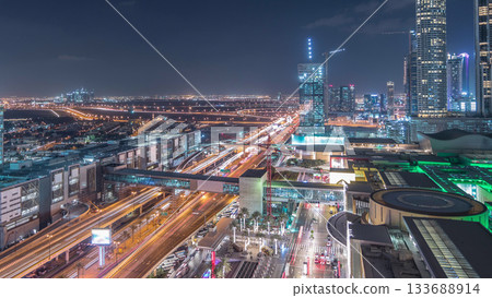 Aerial view of Financial center road night timelapse with under construction building 133688914