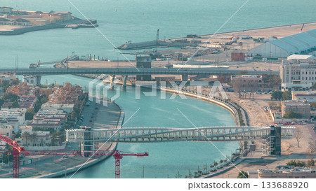 Dubai water canal with footbridge during sunset aerial timelapse from Downtown skyscrapers rooftop 133688920