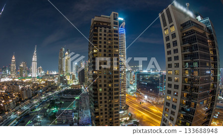 Beautiful skyline of Dubai downtown and Business bay with modern architecture night timelapse. Beautiful skyline of Dubai downtown and Business bay with modern architecture night timelapse. 133688948
