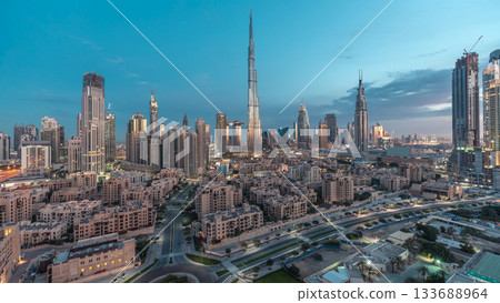Dubai Downtown skyline night to day timelapse with Burj Khalifa and other towers panoramic view from the top in Dubai Dubai Downtown skyline night to day timelapse with Burj Khalifa and other towers panoramic view from the top in Dubai 133688964