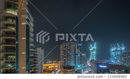 Dubai Marina skyscrapers and promenade aerial night timelapse, Dubai, United Arab Emirates Dubai Marina skyscrapers and promenade aerial night timelapse, Dubai, United Arab Emirates 133688983