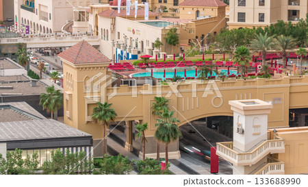 Aerial view of beach and tourists walking and sunbathing on holiday in JBR timelapse in Dubai, UAE Aerial view of beach and tourists walking and sunbathing on holiday in JBR timelapse in Dubai, UAE 133688990