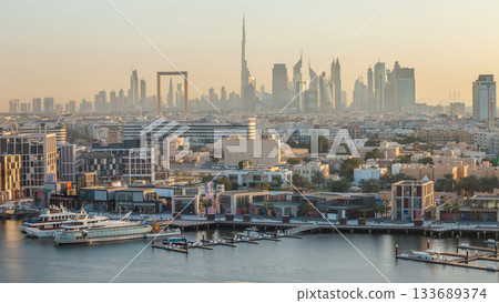 Dubai creek landscape timelapse with waterfront and modern buildings in the background during sunset Dubai creek landscape timelapse with waterfront and modern buildings in the background during sunset 133689374