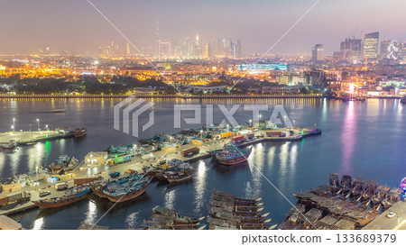 Dubai creek landscape day to night timelapse with boats and ship near waterfront Dubai creek landscape day to night timelapse with boats and ship near waterfront 133689379