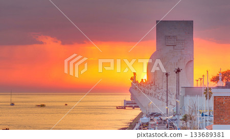 Elevated sunset view of the Padrao dos Descobrimentos Monument to the Discoveries timelapse famous monument on the banks of the River Tagus in Lisbon Elevated sunset view of the Padrao dos Descobrimentos Monument to the Discoveries timelapse famous monument on the banks of the River Tagus in Lisbon 133689381