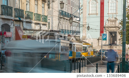 People getting on the tram timelapse, at a station in Luis de Camoes square 133689406