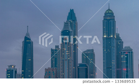Modern skyscrapers in Dubai city night to day timelapse from the Palm Jumeirah Island. 133689535