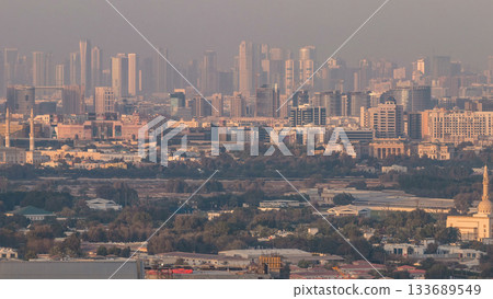 Skyline view of Deira and Sharjah districts in Dubai timelapse at sunset, UAE. 133689549