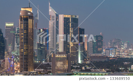 Dubai Downtown day to night timelapse. Aerial view over big futuristic city by night. Dubai Downtown day to night timelapse. Aerial view over big futuristic city by night. 133689550