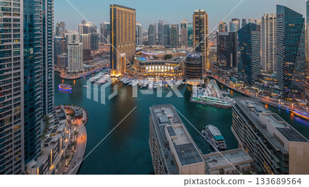 Evening illumination of Dubai Marina day to night aerial timelapse, UAE. Evening illumination of Dubai Marina day to night aerial timelapse, UAE. 133689564