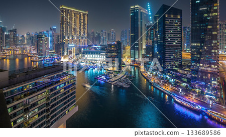 Water canal on Dubai Marina skyline at night timelapse. Water canal on Dubai Marina skyline at night timelapse. 133689586