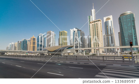 View of Jumeirah lakes towers skyscrapers and metro sration timelapse hyperlapse with traffic on sheikh zayed road. View of Jumeirah lakes towers skyscrapers and metro sration timelapse hyperlapse with traffic on sheikh zayed road. 133689597