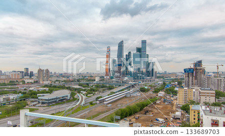 Business complex of skyscrapers Moscow city timelapse. In the foreground the railway and automobile overpass. Business complex of skyscrapers Moscow city timelapse. In the foreground the railway and automobile overpass. 133689703