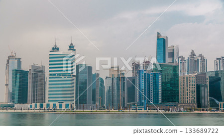 Panoramic timelapse view of business bay and downtown area of Dubai reflection in a river. Panoramic timelapse view of business bay and downtown area of Dubai reflection in a river. 133689722