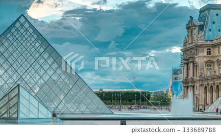 The Louvre museum pyramid at sunset timelapse in Paris, France The Louvre museum pyramid at sunset timelapse in Paris, France 133689788