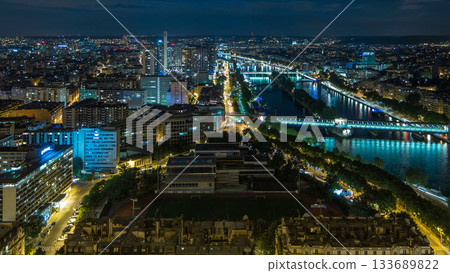 Aerial night timelapse view of Paris City and Seine river shot on the top of Eiffel Tower Aerial night timelapse view of Paris City and Seine river shot on the top of Eiffel Tower 133689822