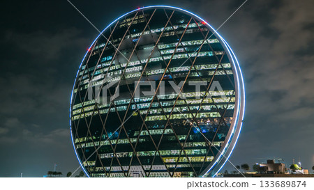 The Aldar headquarters building night timelapse is the first circular building of its kind in the Middle East in Abu Dhabi, UAE The Aldar headquarters building night timelapse is the first circular building of its kind in the Middle East in Abu Dhabi, UAE 133689874