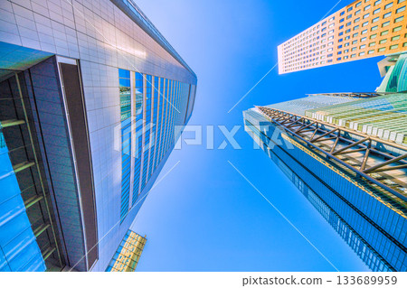 Tokyo cityscape in Japan. Shiodome business district. View of Kyodo News and Nippon Television Tower reflected in the window. 133689959