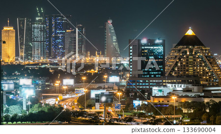 Dubai downtown skyline timelapse at night. Rooftop view of Sheikh Zayed road with numerous illuminated towers. 133690004