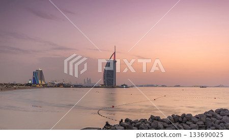 Dubai skyline with Burj Al Arab hotel day to night timelapse. Dubai skyline with Burj Al Arab hotel day to night timelapse. 133690025
