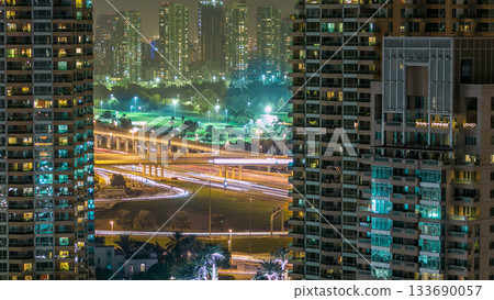Golf field timelapse from top at night time with traffic on sheikh zayed road. Golf field timelapse from top at night time with traffic on sheikh zayed road. 133690057