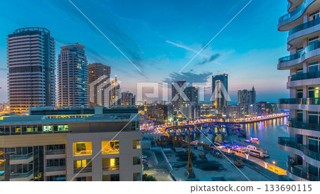 An Aerial view of Dubai Marina towers in Dubai day to night timelapse 133690115