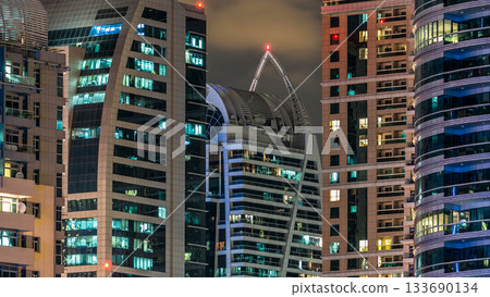 Close View of Dubai Marina towers in Dubai at night timelapse Close View of Dubai Marina towers in Dubai at night timelapse 133690134