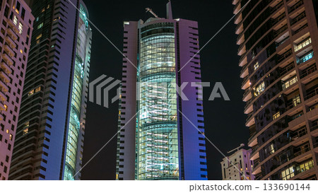 Close View of Dubai Marina towers in Dubai at night timelapse 133690144