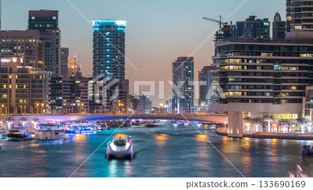 Dubai Marina towers and canal in Dubai day to night timelapse 133690169