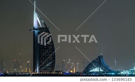 Skyline of Dubai at night timelapse with Burj al Arab in foreground in Dubai, United Arab Emirates 133690183