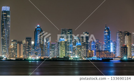 Dubai Marina skyline night timelapse as seen from island in Dubai, UAE. Dubai Marina skyline night timelapse as seen from island in Dubai, UAE. 133690184