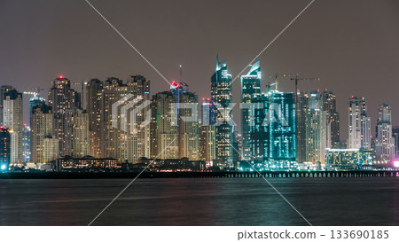 Dubai Marina skyline night timelapse as seen from island in Dubai, UAE. 133690185