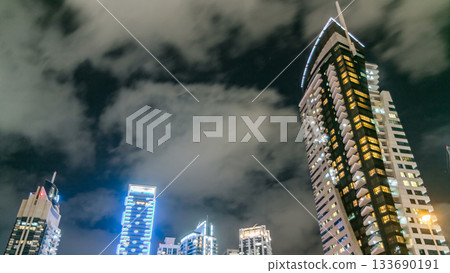 Dubai Marina towers look up view in Dubai night timelapse 133690191